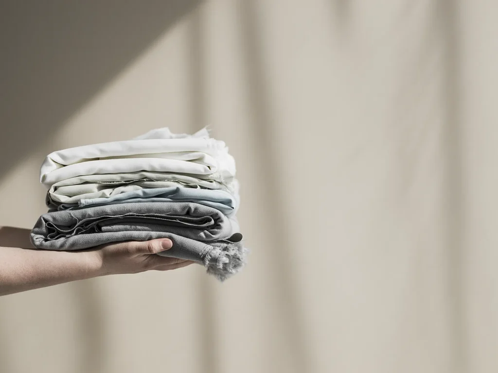 Circle Textiles folded and held up by hands. circular textiles