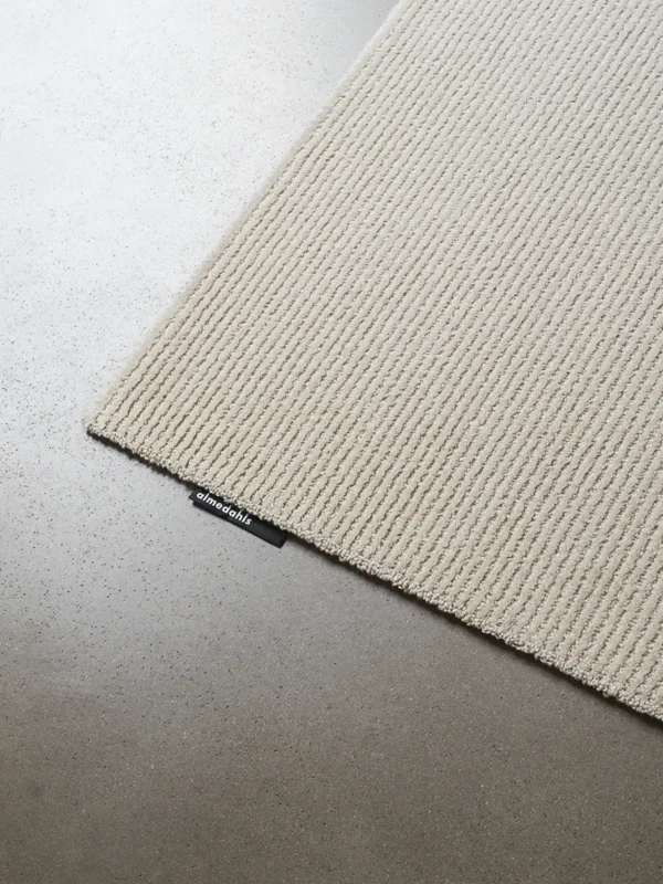 Photo of our rug Sow from our Field collection with loggo