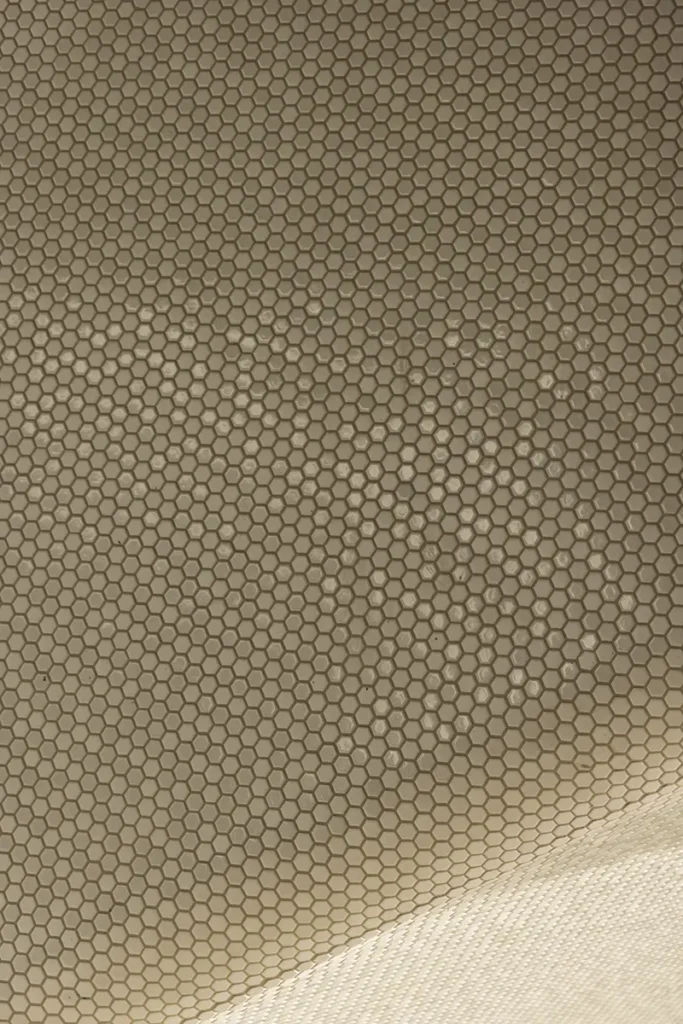 Abstract architectural surface with a repeating hexagonal pattern.