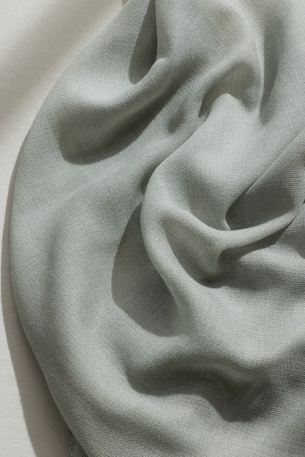 Detail of ZEN transparent hanging textile with a refined woven texture and soft drape.