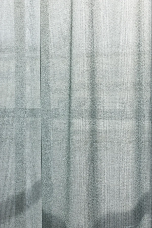 ZEN transparent hanging textile filtering daylight with a subtle woven texture.