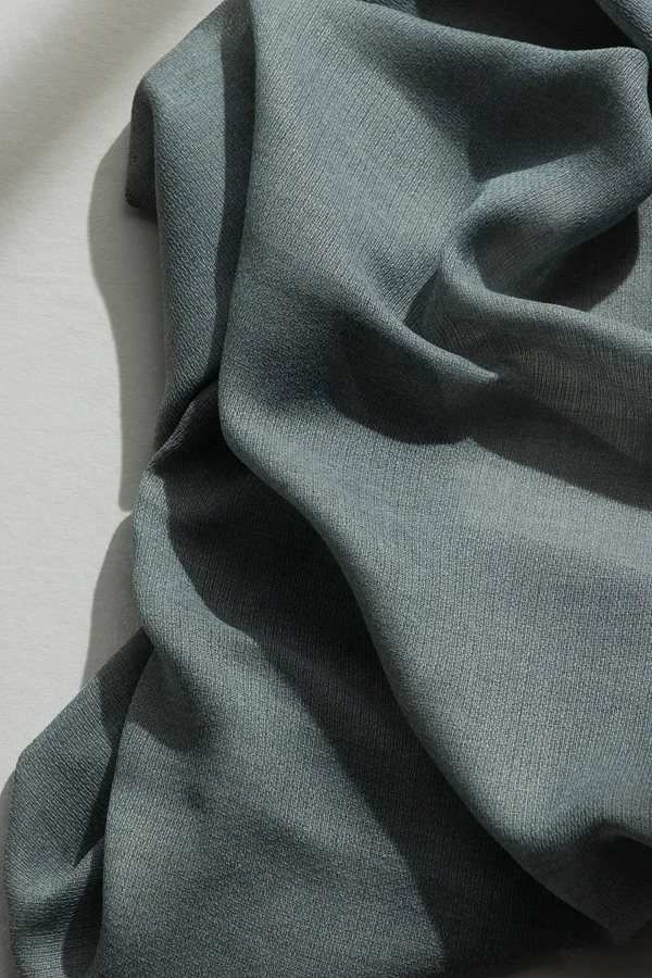 Detail of ZEN transparent hanging textile with a refined woven texture and soft drape.