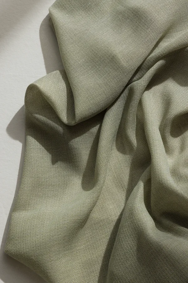 Detail of ZEN transparent hanging textile with a refined woven texture and soft drape.