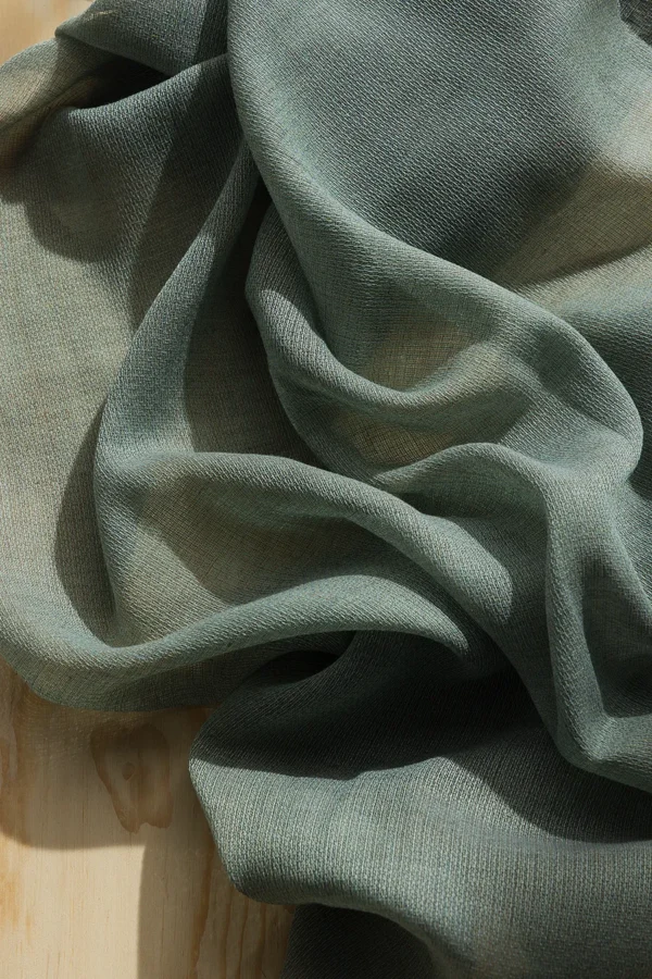 Detail of ZEN transparent hanging textile with a refined woven texture and soft drape.
