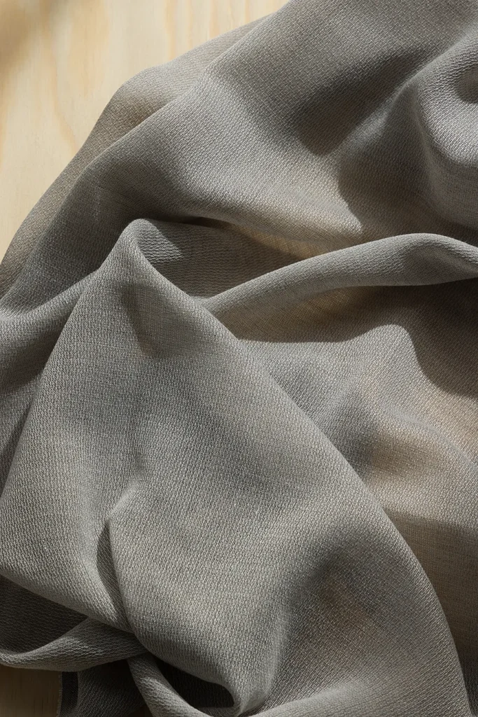 Detail of ZEN transparent hanging textile with a refined woven texture and soft drape.