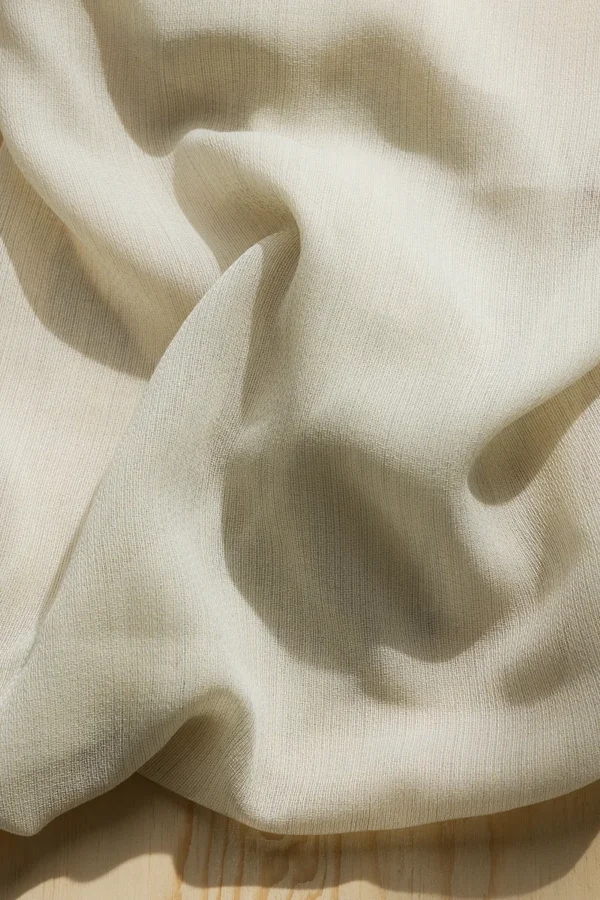 Detail of ZEN transparent hanging textile with a refined woven texture and soft drape.