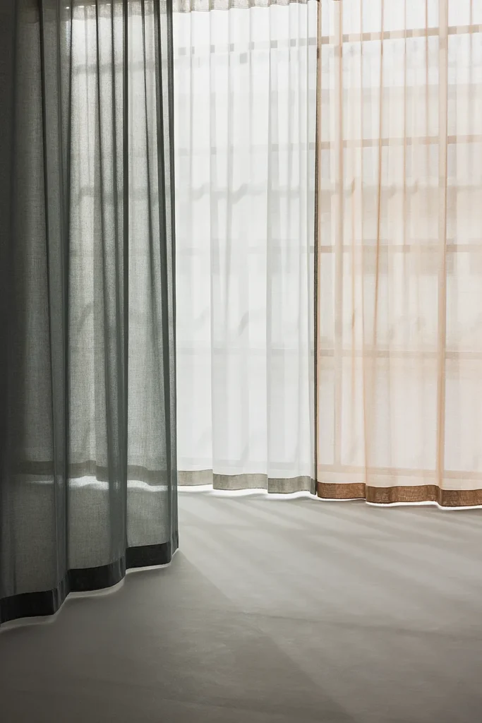 ZEN transparent hanging textile in layered neutral tones, softly filtering daylight.