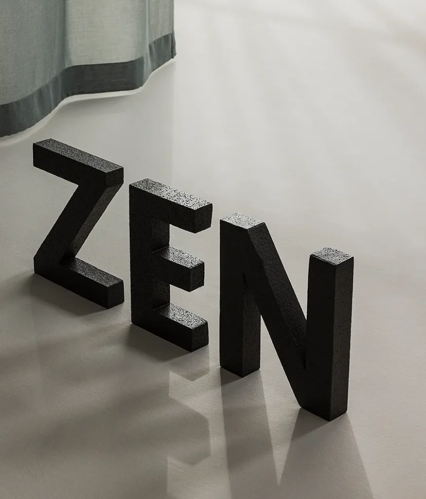 ZEN transparent hanging textile layered with Panorama, shown behind sculptural letter forms.