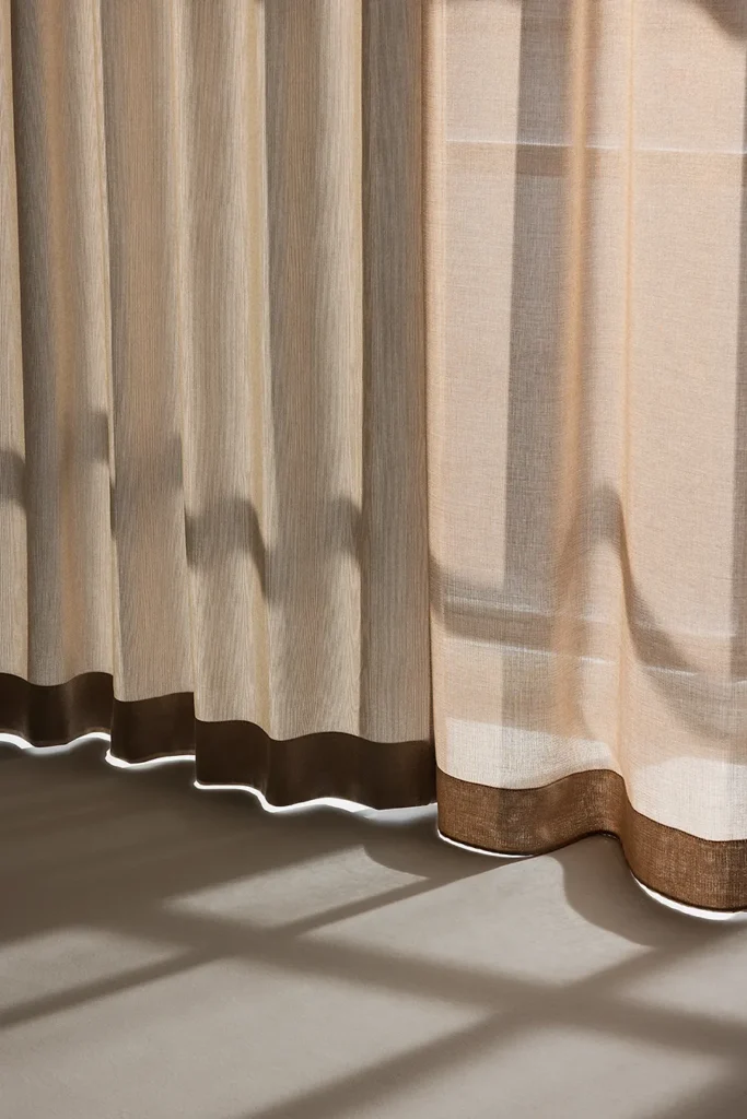 ZEN transparent hanging textile layered with Panorama, softly filtering daylight in a calm interior setting.