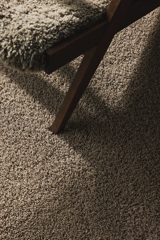 Dark brown VILA rug showing texture and light in an interior setting.